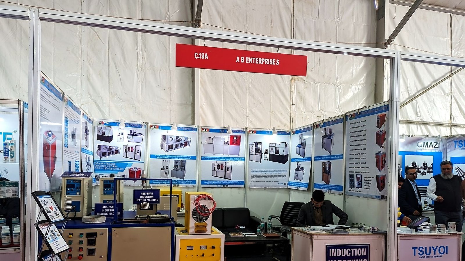 Our stand at an industrial exhibition, showing induction heating machines, an induction hardening machine and electroplating rectifiers, with product information boards behind.
