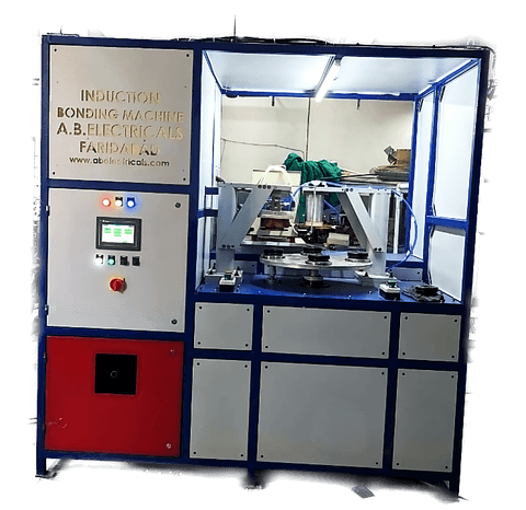 An induction bonding machine with its guarding open, showing the work station, the control panel and the induction power supply behind.